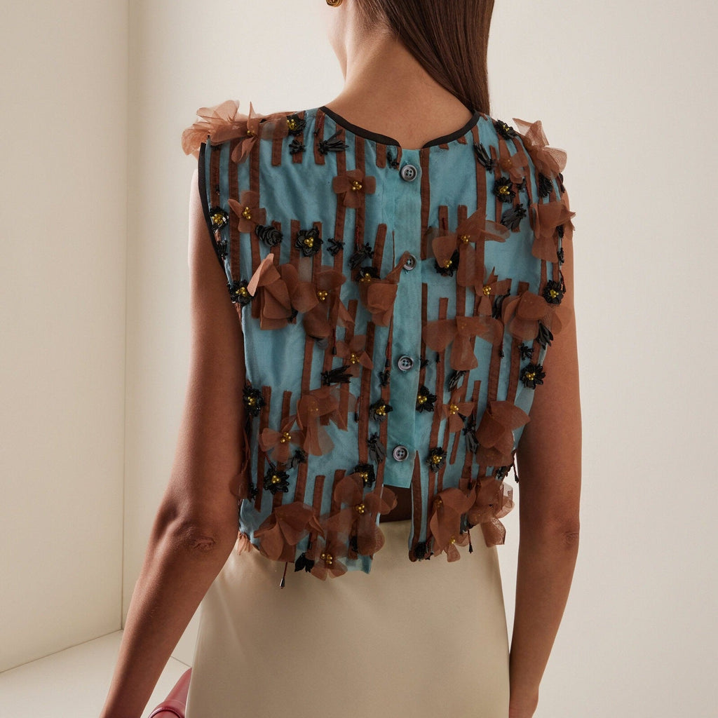 Sleeveless top with blue striped appliqués