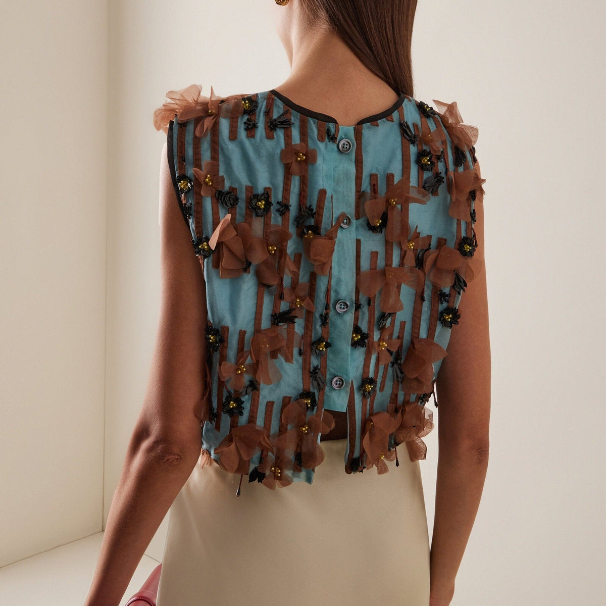 Sleeveless top with blue striped appliqués